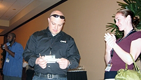 New OMTI Technical Support staffer Dustin Scoggin punches conference attendees' CEU cards. 